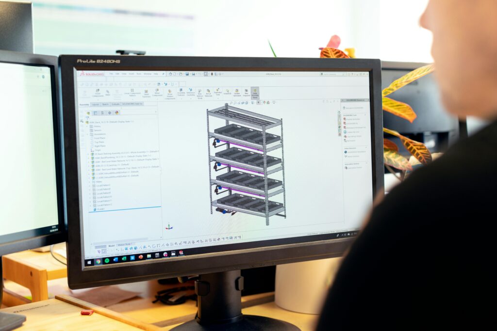 Close-up of an engineer using CAD software for vertical farm design on a desktop computer.